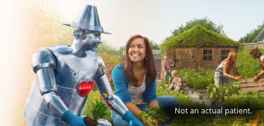 Tin Man and a woman gardening together.